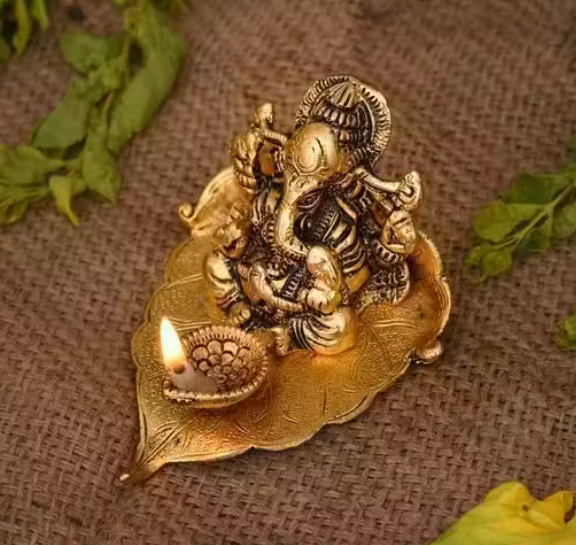 Ganesh Idol Sitting on Pipal Leaf with Diya Gold Plated Metal Statue