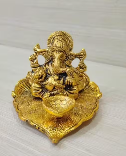 Ganesh Idol Sitting on Pipal Leaf with Diya Gold Plated Metal Statue