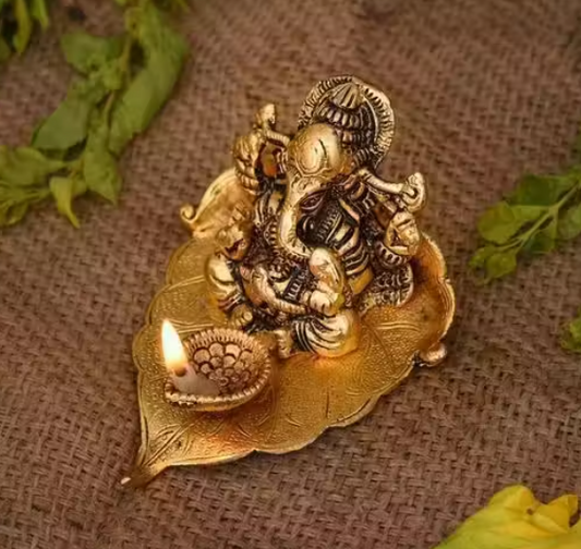Ganesh Idol Sitting on Pipal Leaf with Diya Gold Plated Metal Statue